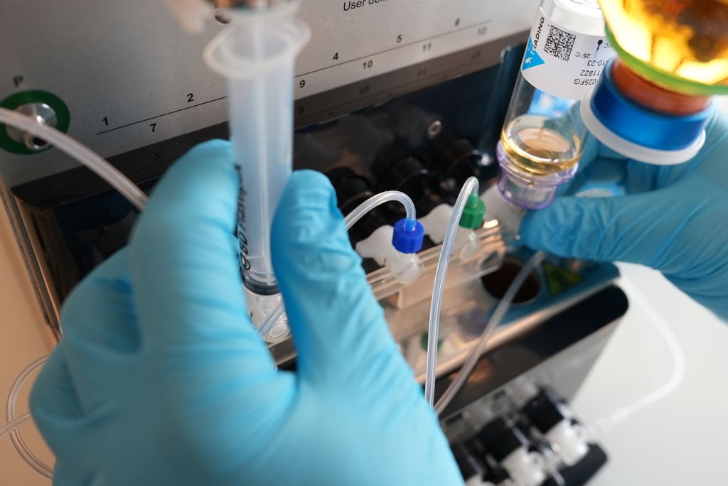 Operator using the Sterinow® system within a shielded environment to prepare QC samples